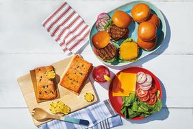 A spread for burgers and salmon on a white surface. 