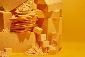 stack of different kinds of American cheeseâshredded, blocks, slices