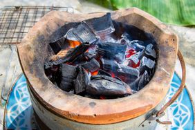 Binchotan charcoal burning in an old stove.