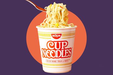 A photo composite of a cup of Nissin Cup Noodles on an orange and purple background.