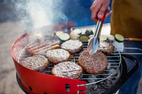 Juicy burgers and sausages on a charcoal grill. 