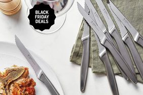 A set of Henckels steak knives on a table with food and wine and a Black Friday Deals badge.