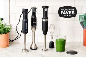 Best immersion blenders displayed on a kitchen counter with a green juice