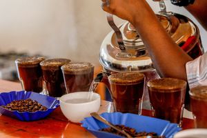 Hot water being poured into a mug at a coffee shop