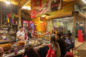 An interior view of a vendor with customers at La Merced Market in Mexico City