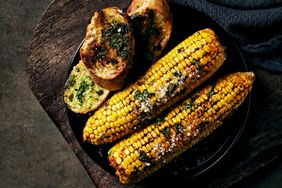 Roasted corn on the cob with spices, herbs and toasts.