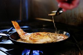 A fish being pan fried.