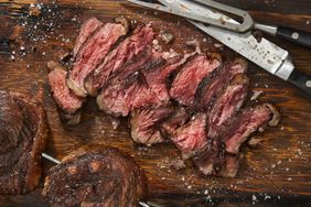 Brazillian picanha steaks sliced on a board.