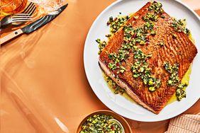 SEARED SALMON WITH PISTACHIO PESTO on a white plate