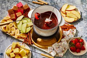 Spiced chocolate fondue with dippers like apples, bananas, and marshmallows