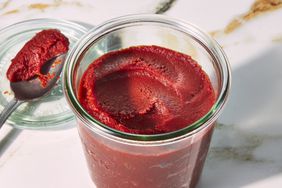 Homemade tomato paste in a glass jar.