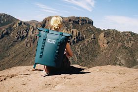 woman wearing Yeti Hopper M20 Backpack Cooler on a cliff